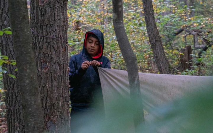 a student assembles a shelter on a backpacking trip for teens near DC